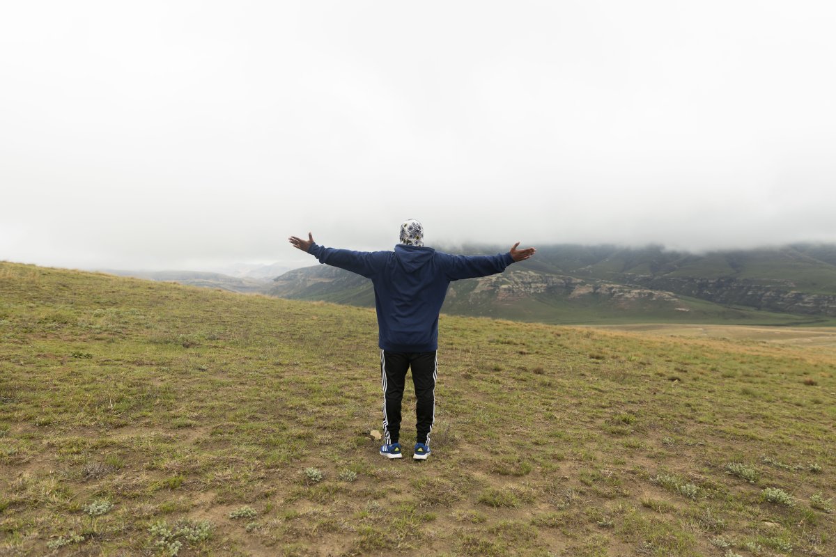 Black man standing in the mountains