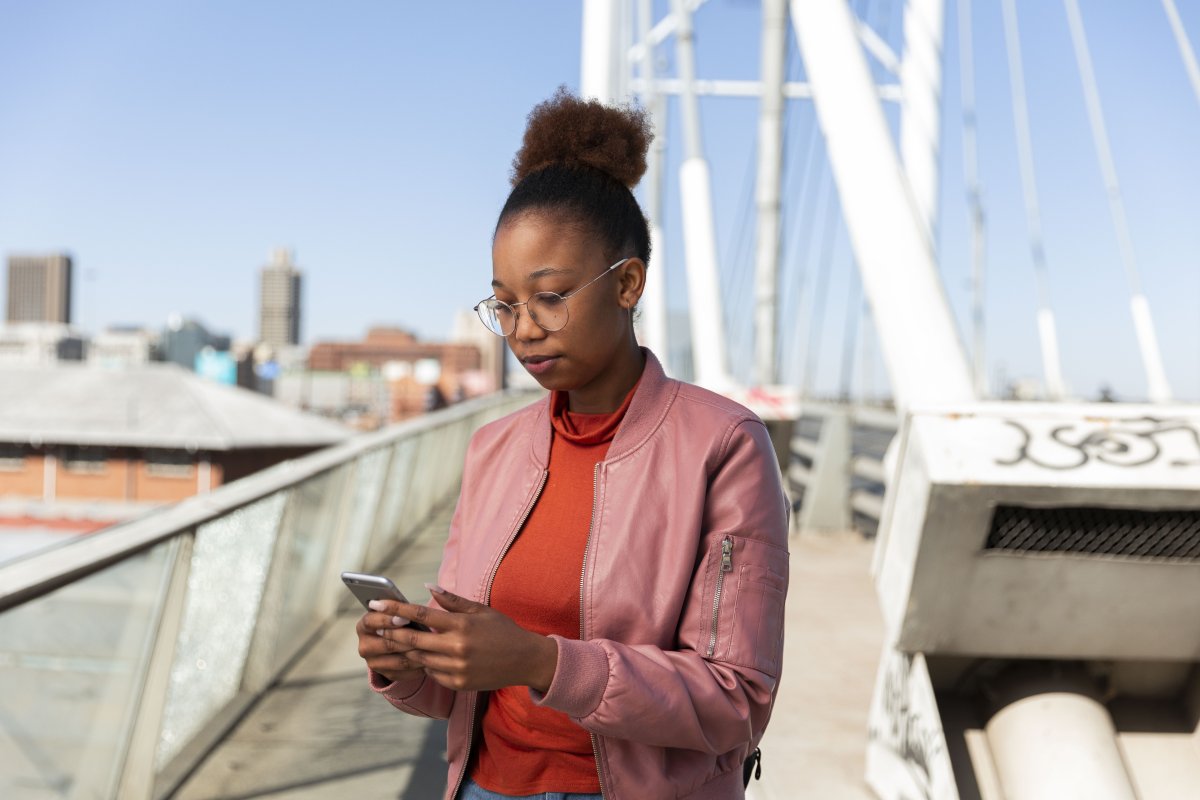 Black woman on a cellphone on Nelson Mandela bridge