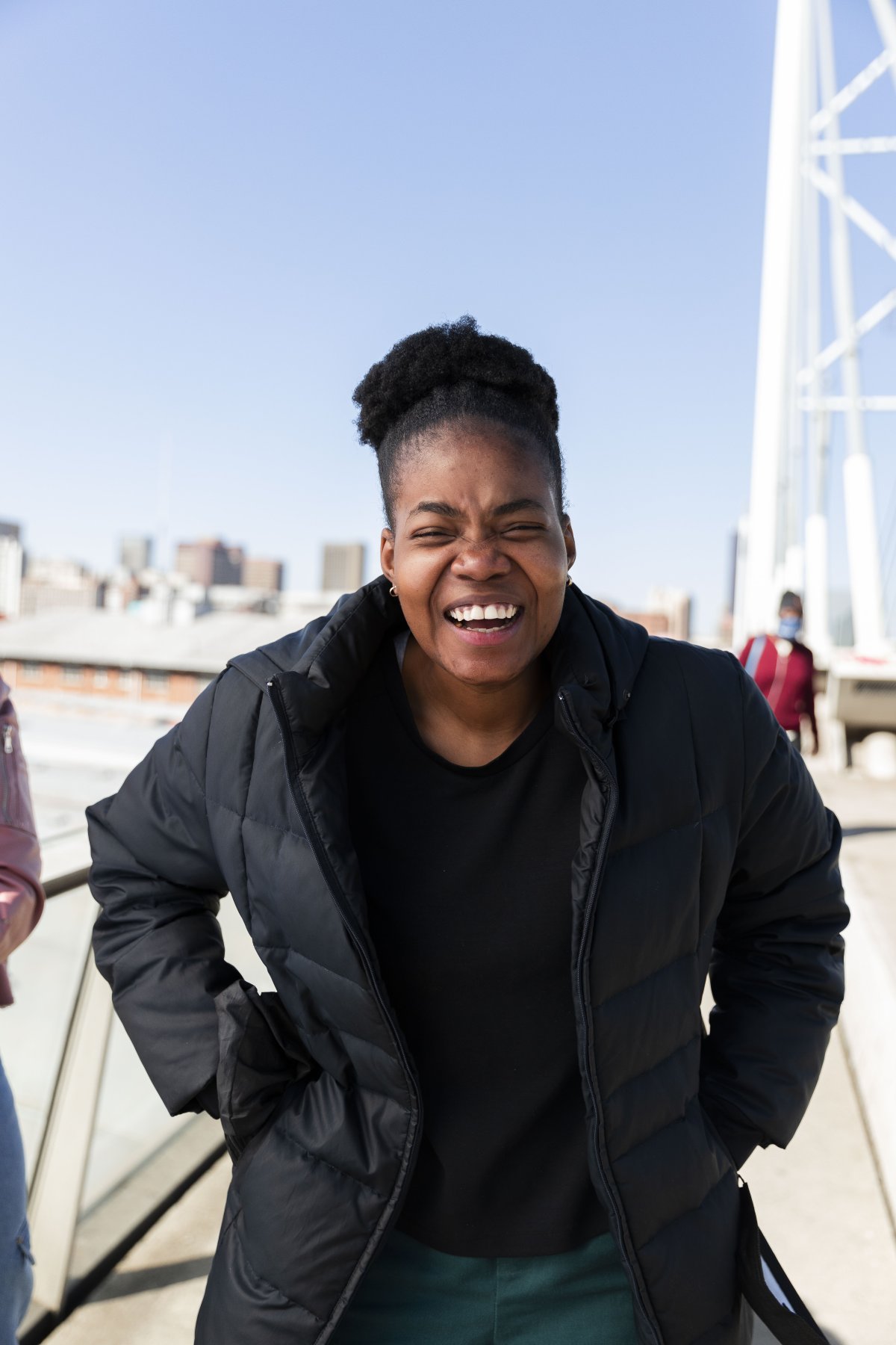 Black woman laughing on nelson Mandela bridge