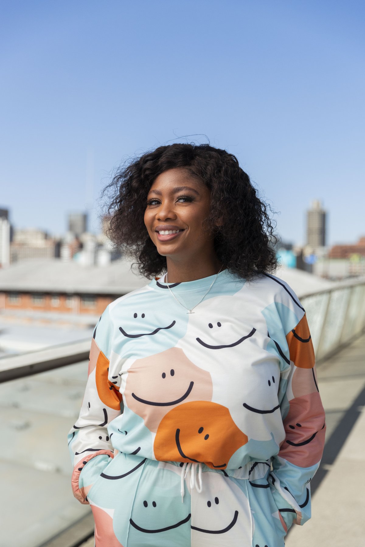Black woman smiling on Nelson Mandela bridge alt