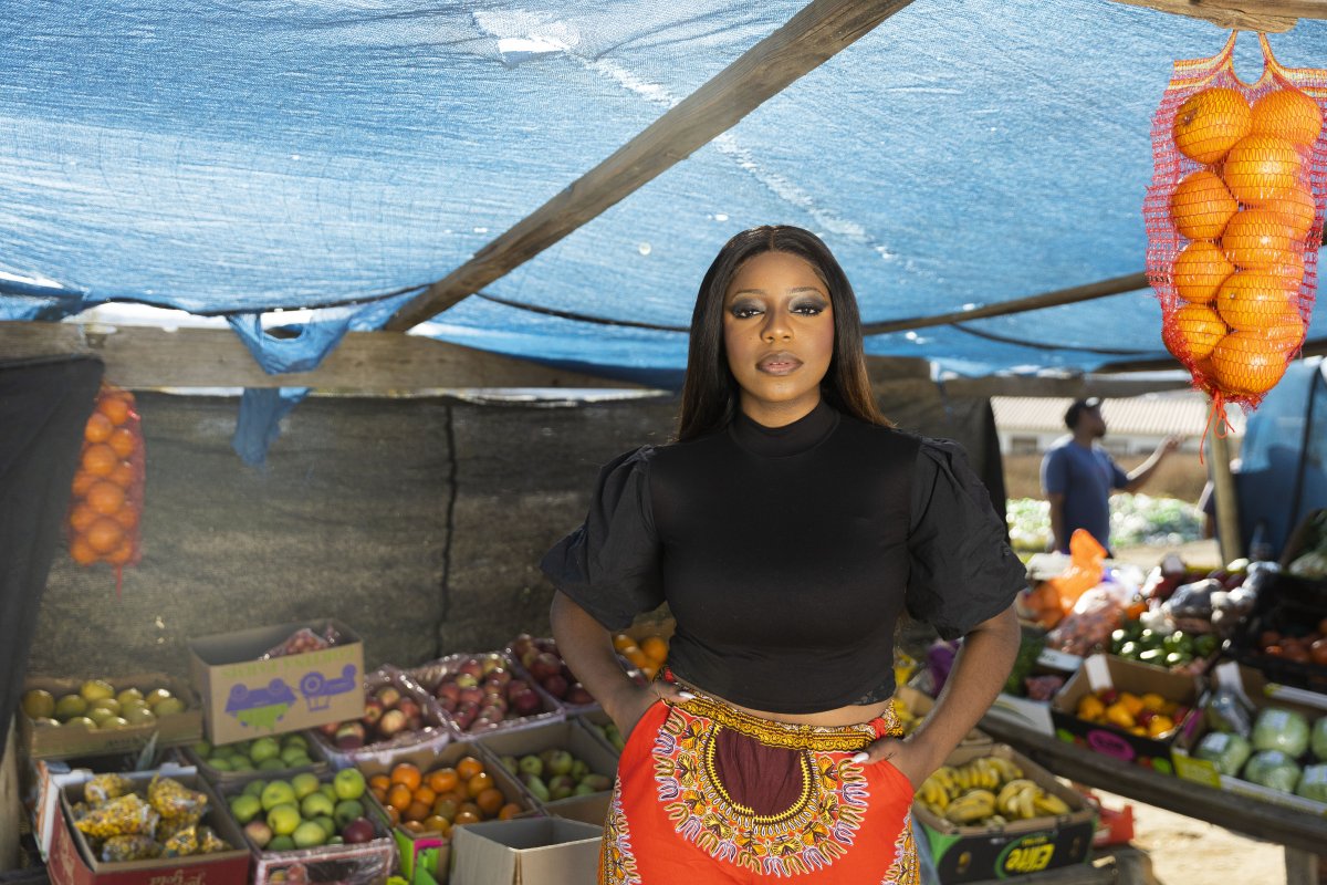 Black woman at the fruit market looking at the camera