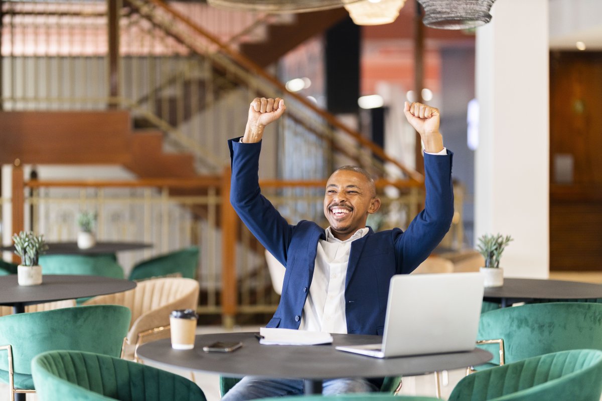 Black business man at work celebrating