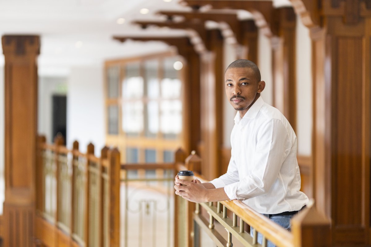 Black business man at work holding coffee