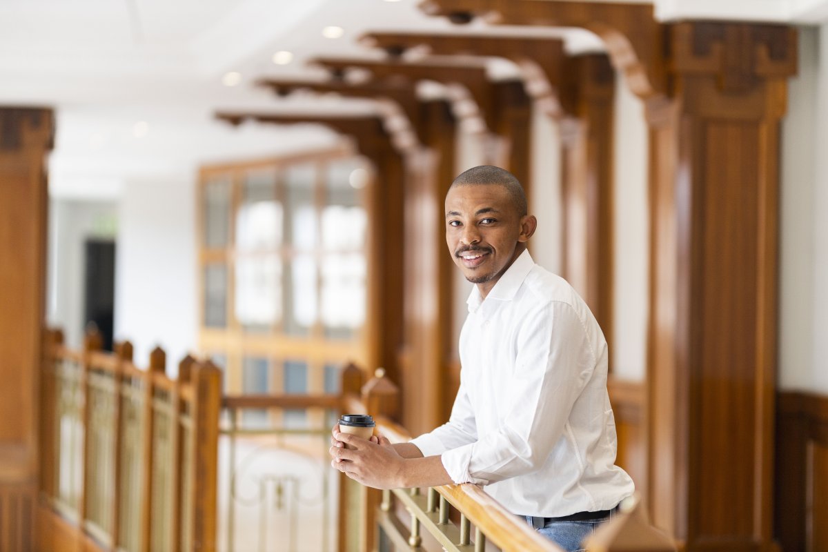 Black business man at work holding coffee