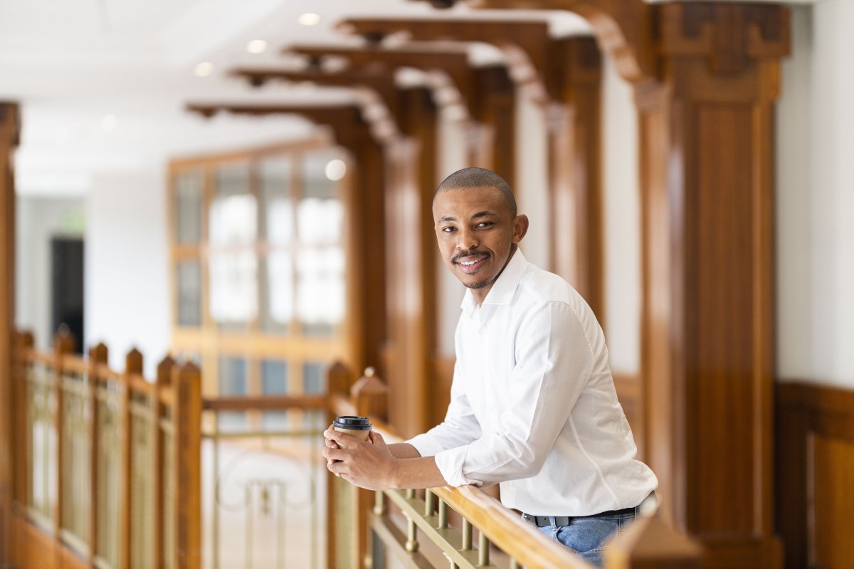 Black business man at work holding coffee