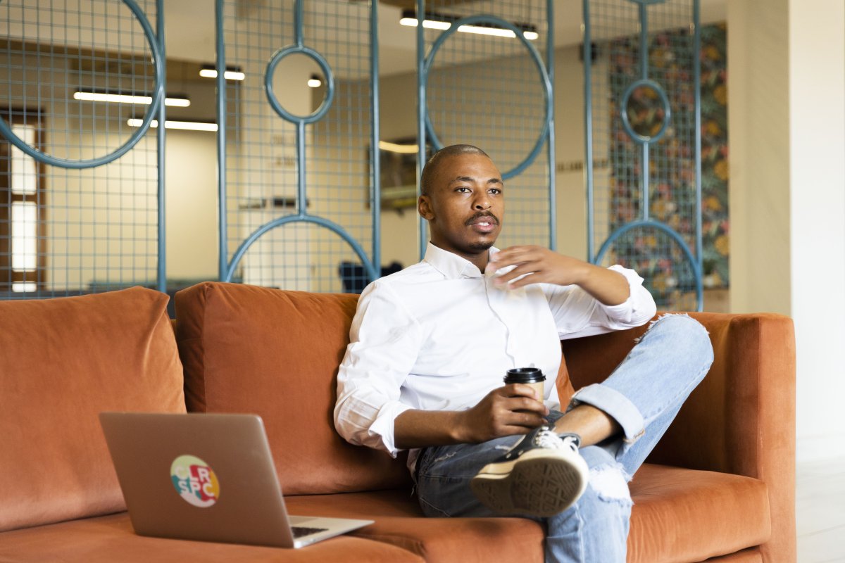 Black business man talking and working on his laptop at the office