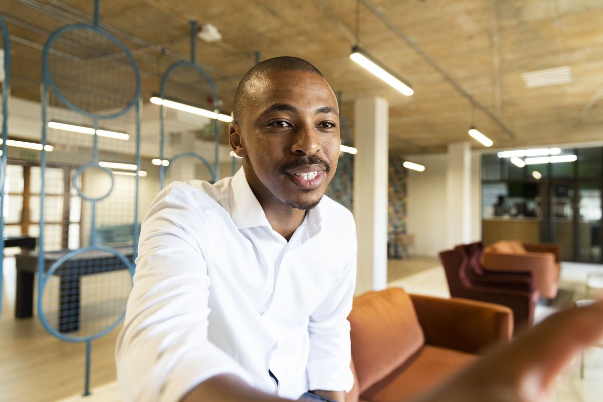 Black business man approaching to shake hands with a client at work
