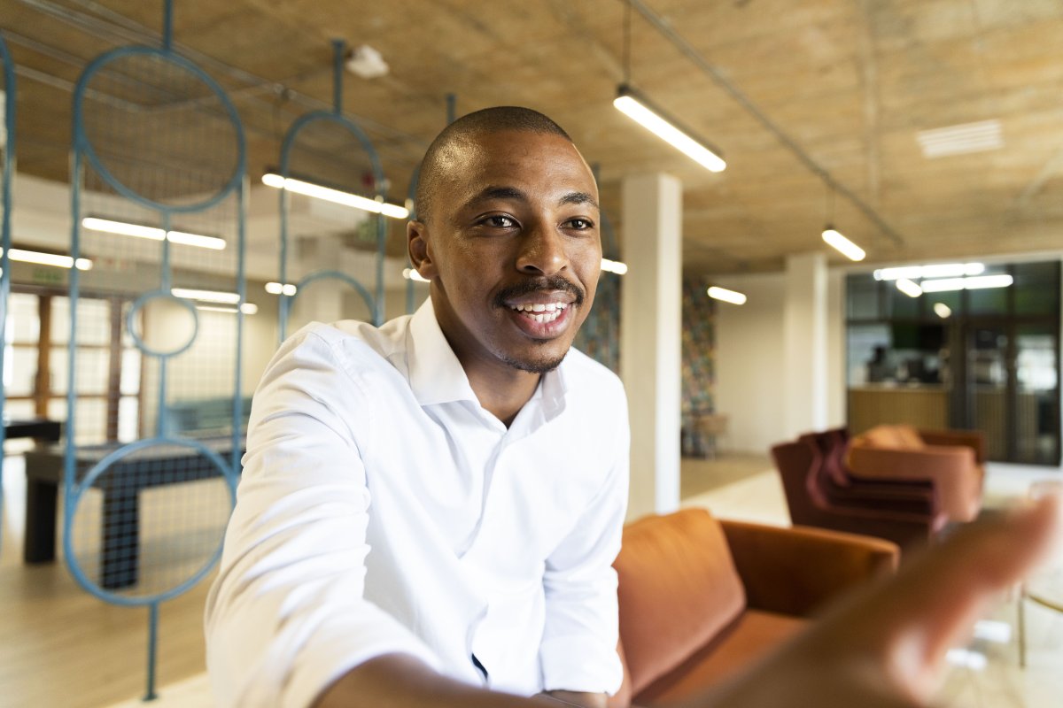 Black business man approaching to shake hands