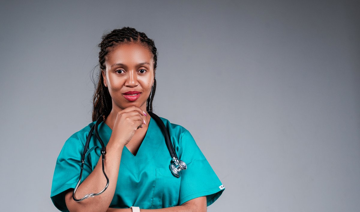 African female doctor confidently posing for the camera with stethoscope.