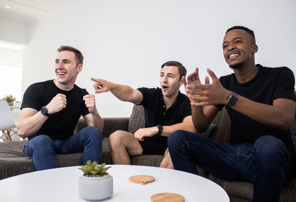 Group of men watching television