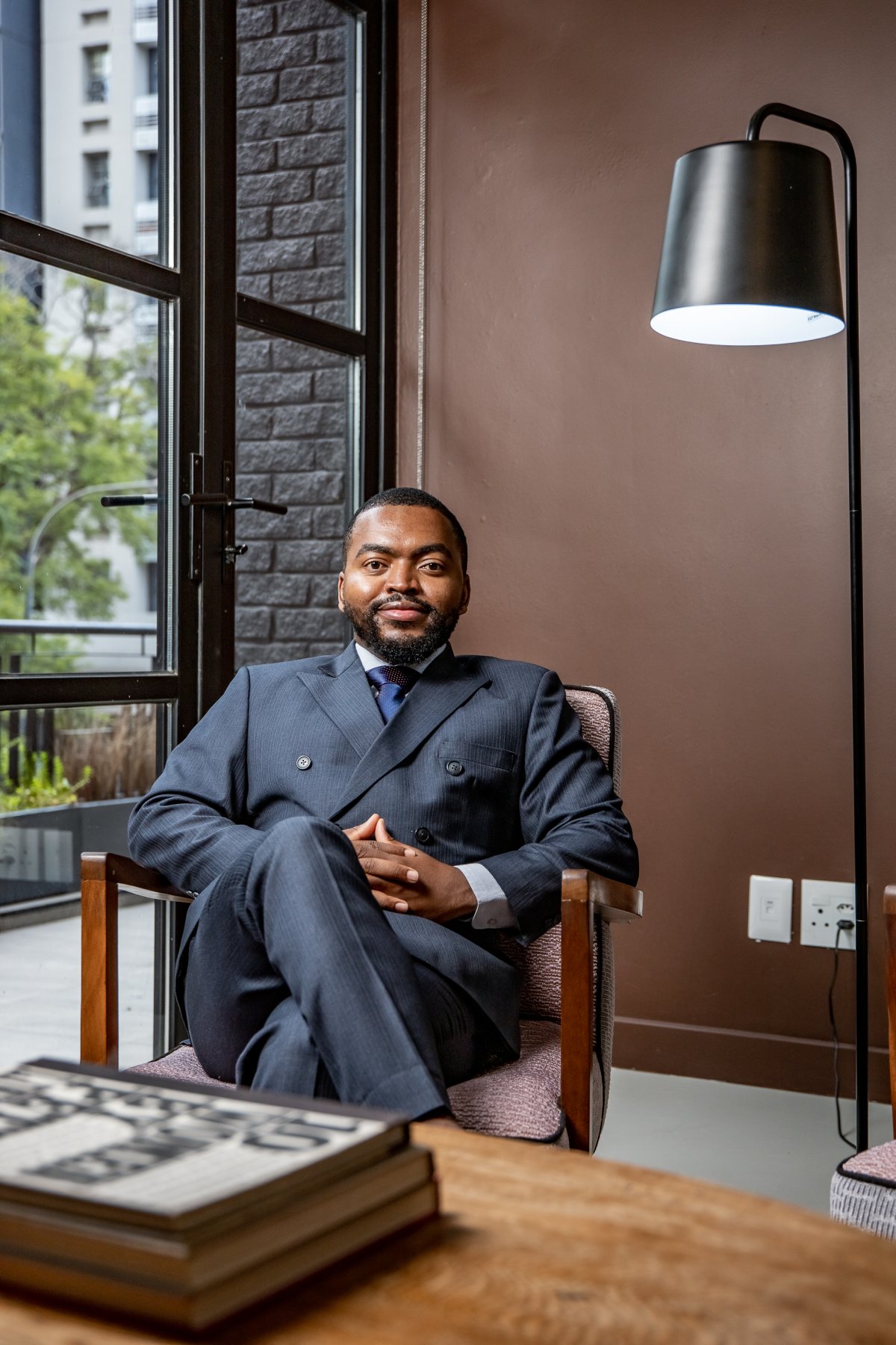 Portrait of corporate man sitting on chair smiling