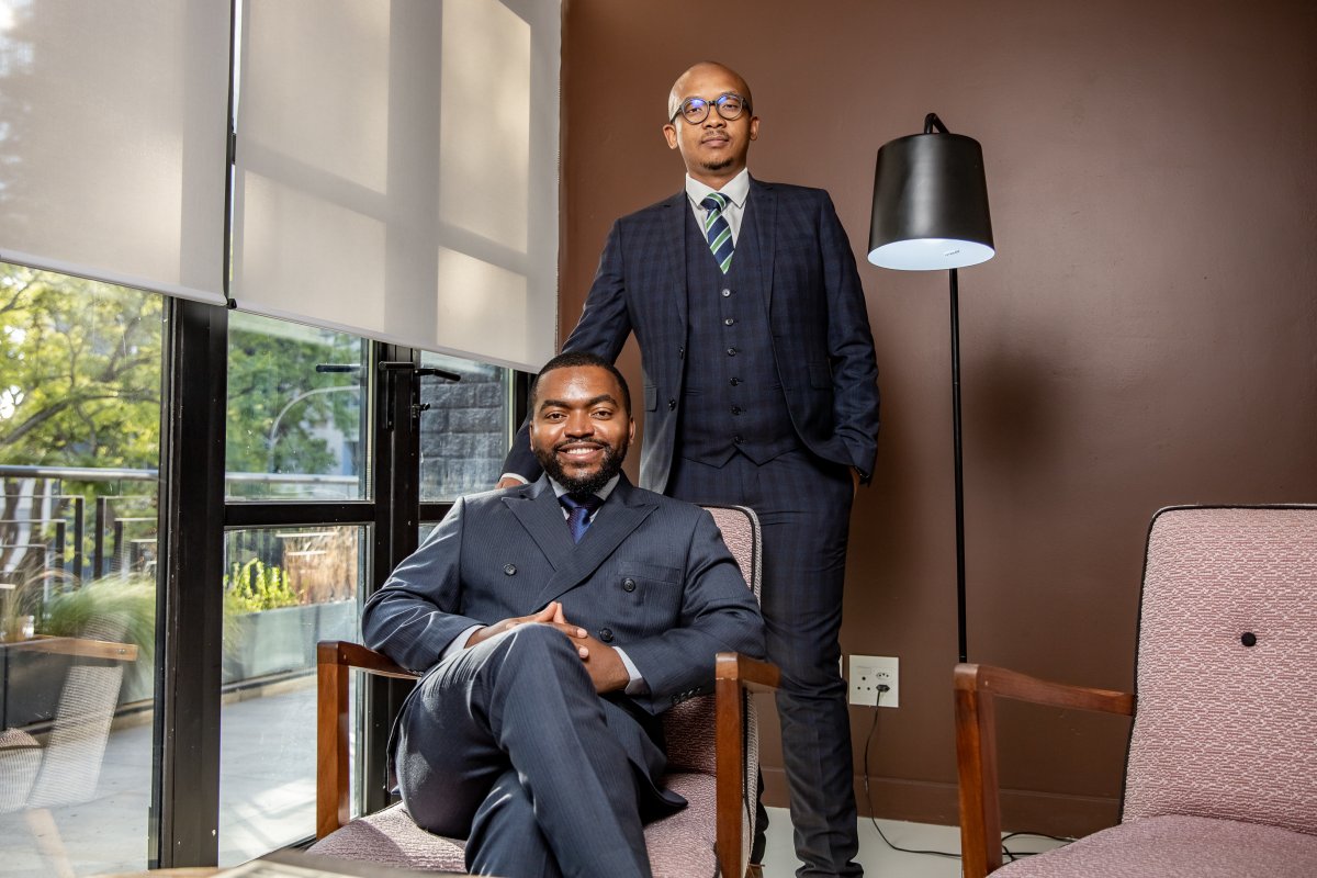 Two businessmen posing for a portrait in the office