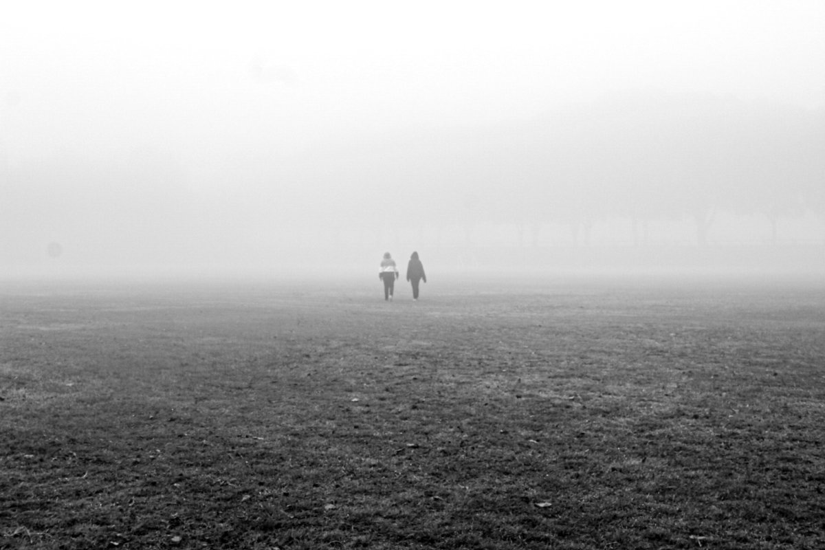 Couple walking in the mist
