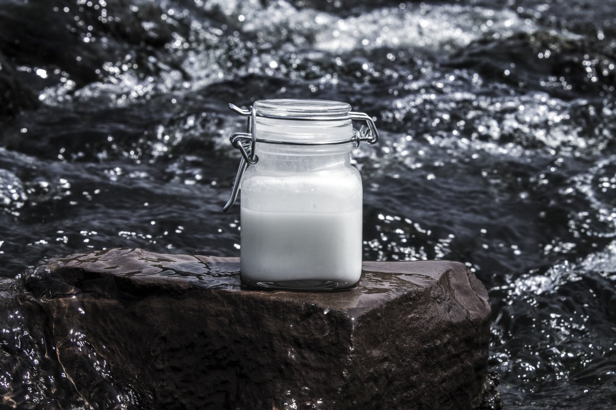 White product bottle on a rock