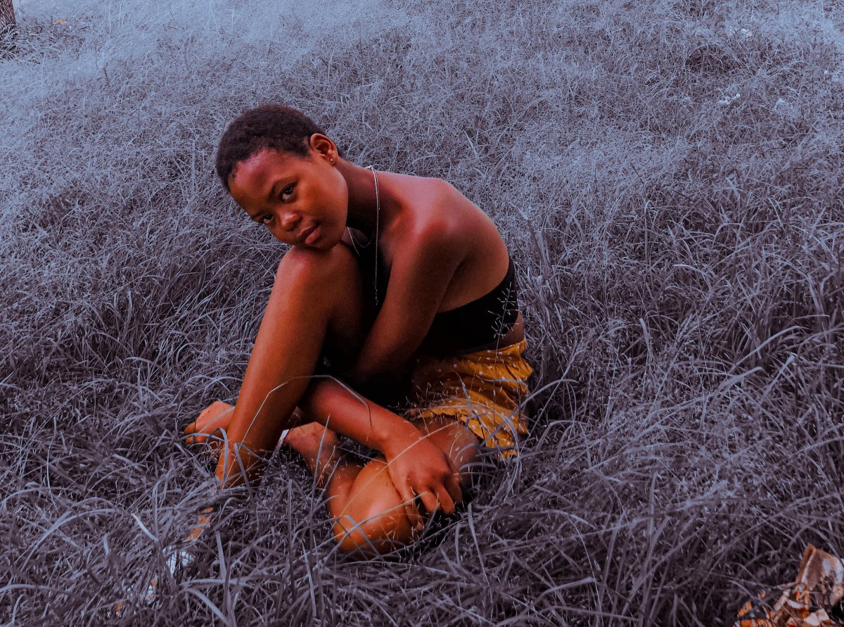 Black girl sitting on grass