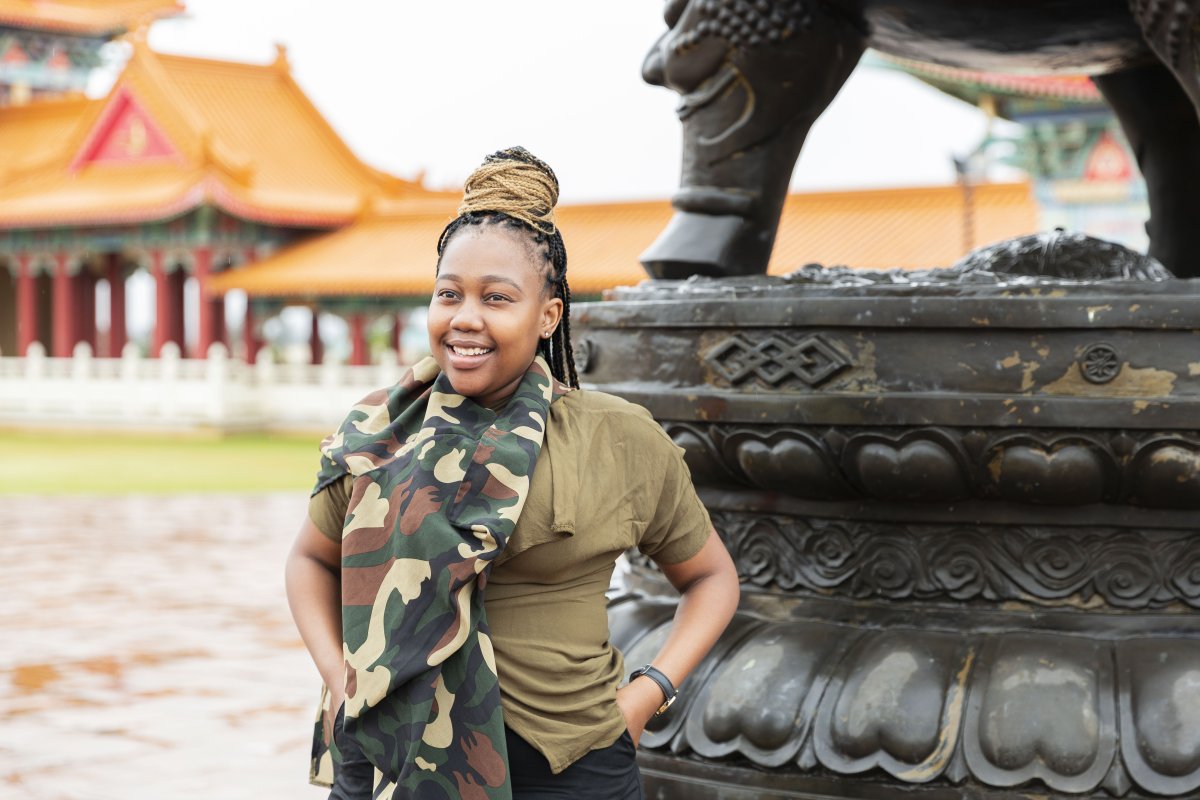 Black woman smiling at a Chinese tourist location