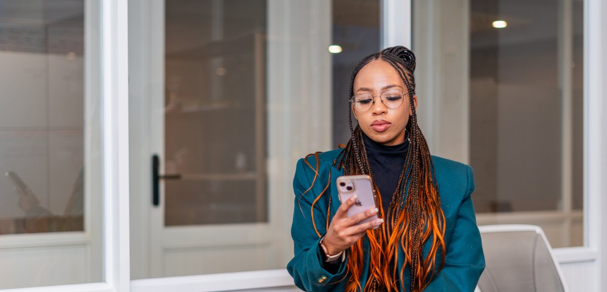 Black woman looking at phone