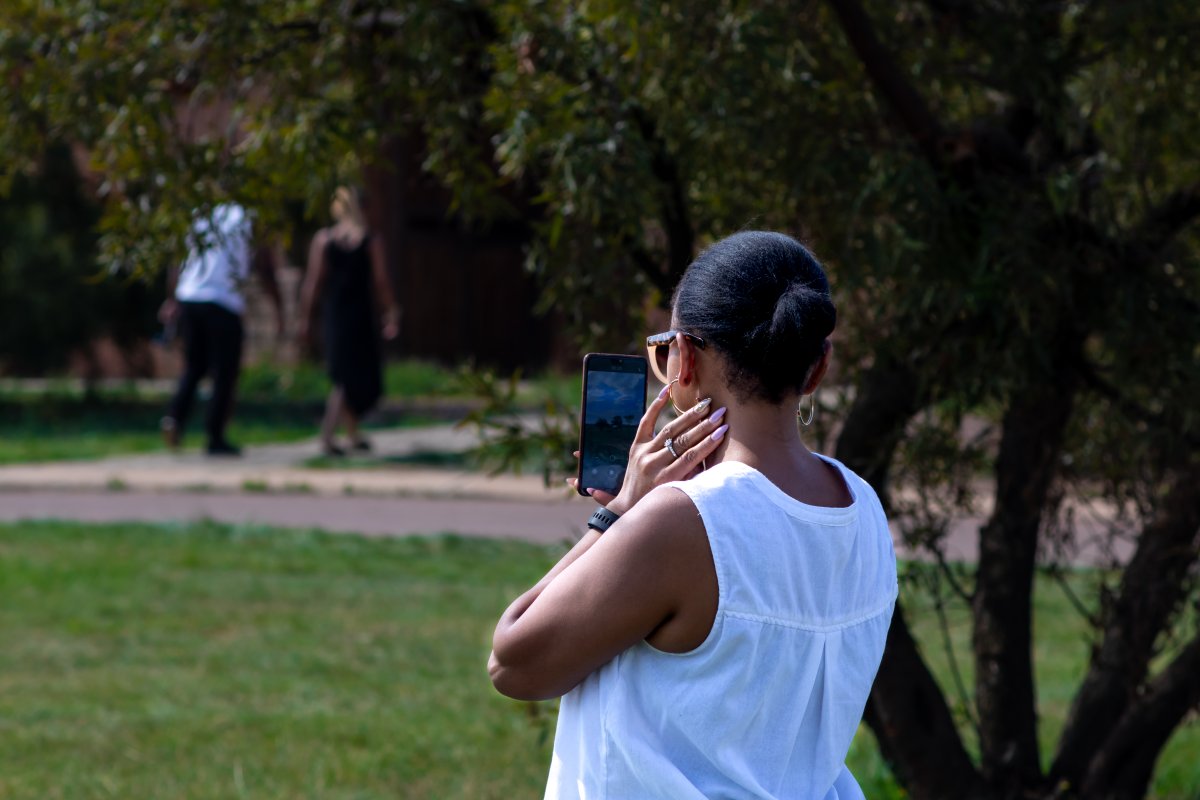 Lady wearing white on a sunny day  taking a selfie