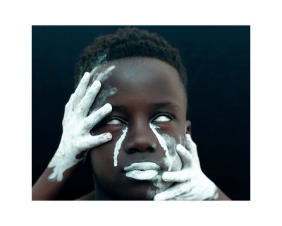 Young black man covered in white ash
