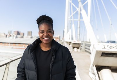 Black woman wearing all black smiling