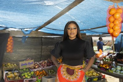 Black woman at the fruit market looking at the camera