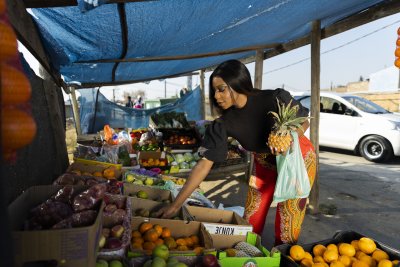 Black woman buying fruits