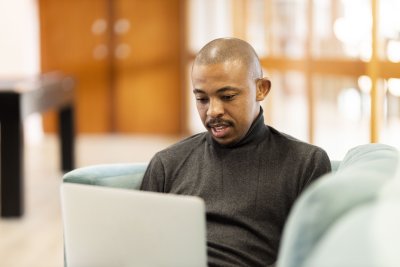 Black man working on his laptop at home