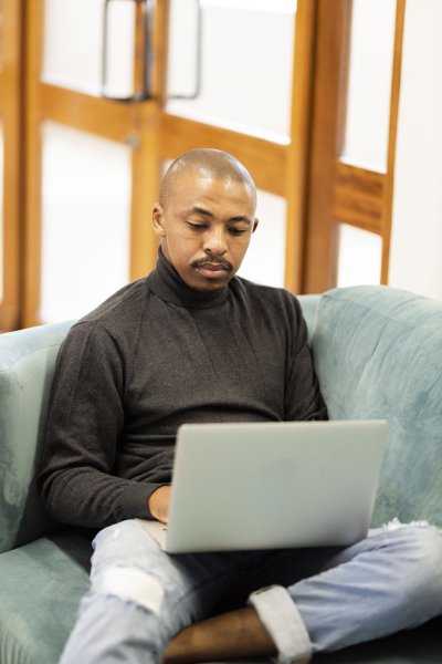 Black man working on his laptop at home