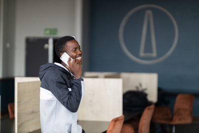 Black man talking on his cellphone and smiling