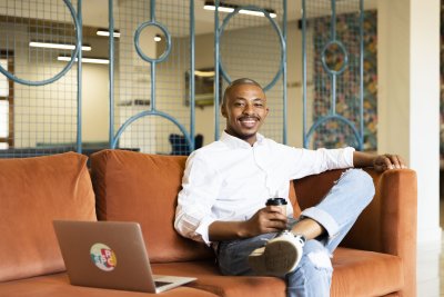 Black business man smiling and looking at the camera at the office
