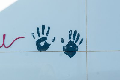 Two baby hand prints on a wall