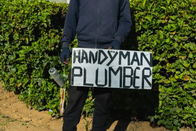 Handyman and plumber sign with a paint brush.