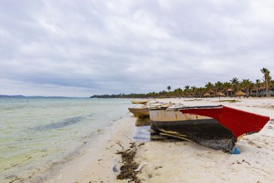 Boats near a lagoon of water on a gloomy day.