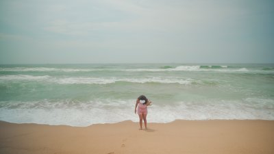 Black woman at Umhlanga beach enjoying the water