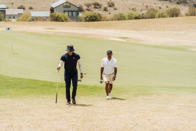 Black male golfers walking to the next hole