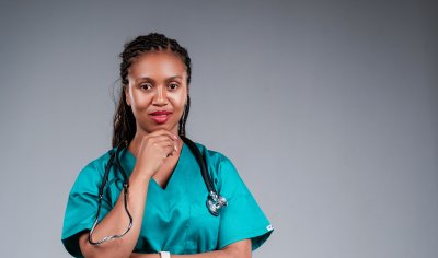 African female doctor confidently posing for the camera with stethoscope.