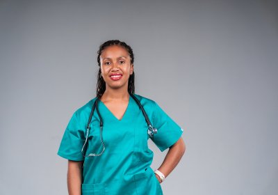 Young female doctor wearing stethoscope smiling at camera.