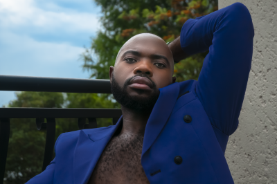 Black male wearing blue coat