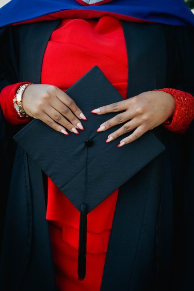 Black woman hands holding graduation hat