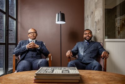 Business men sitting in the office smiling