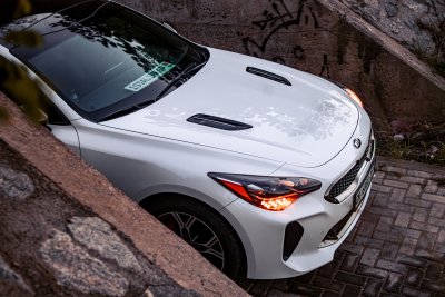 A KIA Stinger under a Bridge