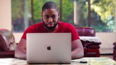 Black man working on laptop