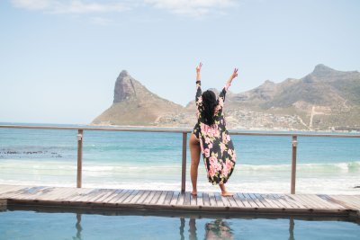Black woman posing by the ocean in Cape Town