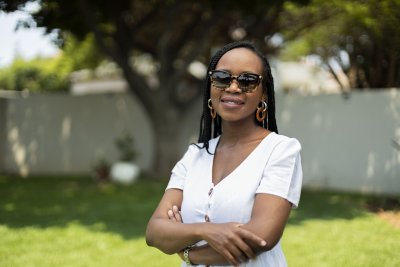 Black woman wearing glasses smiling