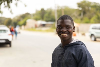 Black boy smiling and looking at the camera