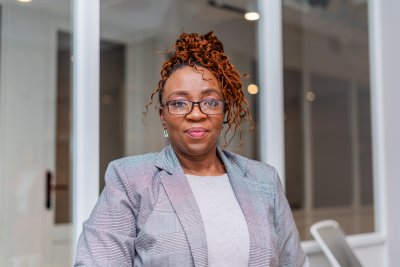 Portrait of mature black business woman at the office wearing glasses.