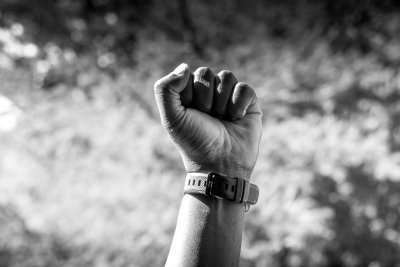Black and white shot on male fist in sunlight.