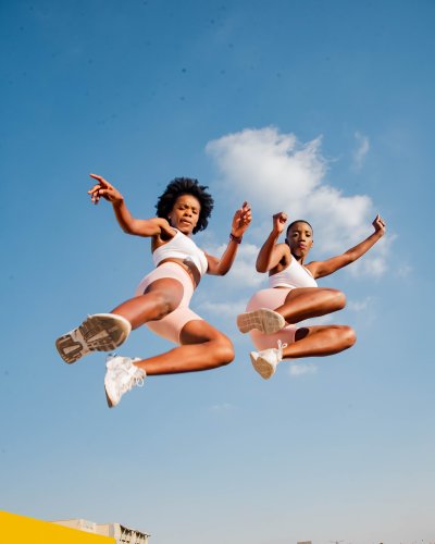 Two black  women exercising on a rooftop